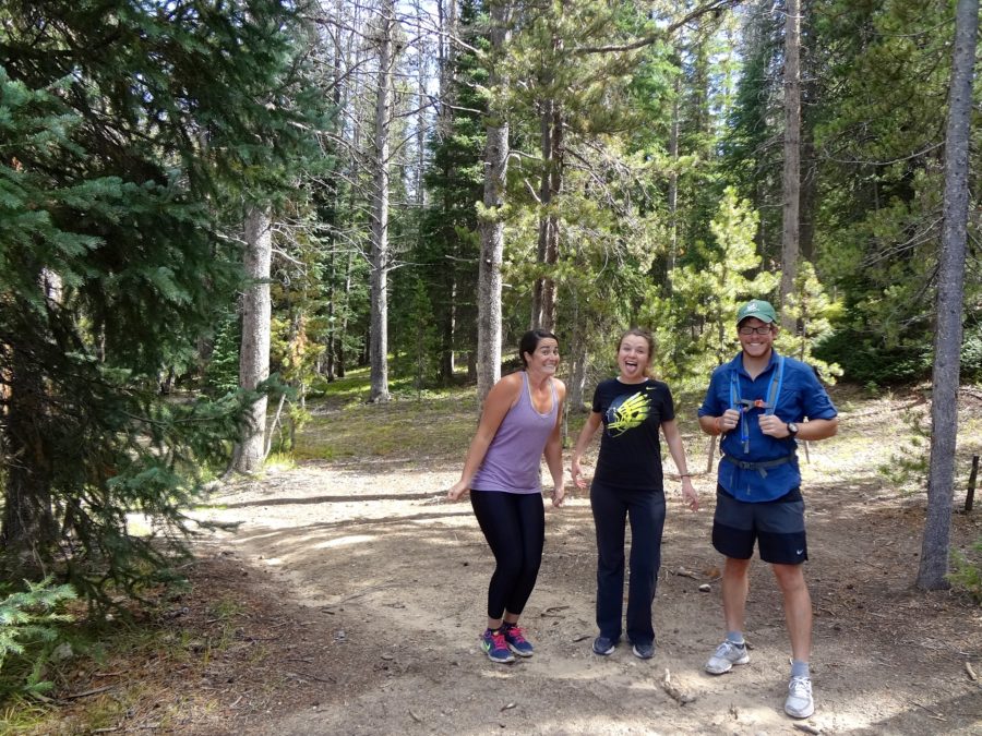 Three people smile for a photo.