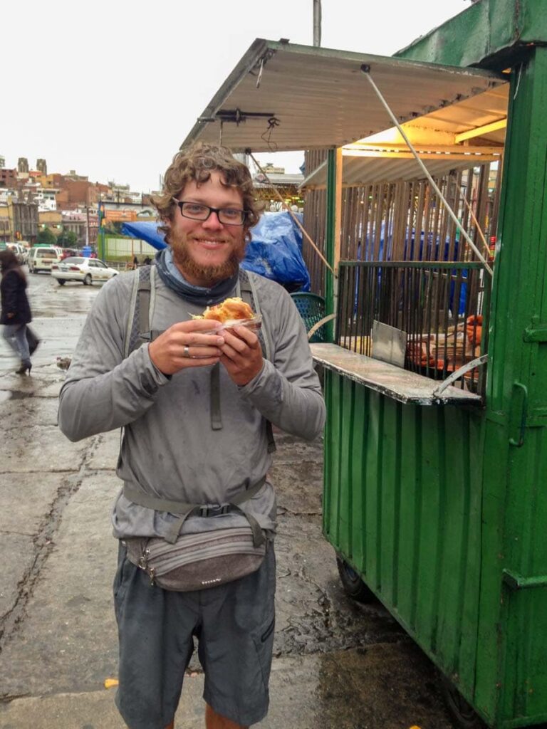 Man eating street food in Bolivia.