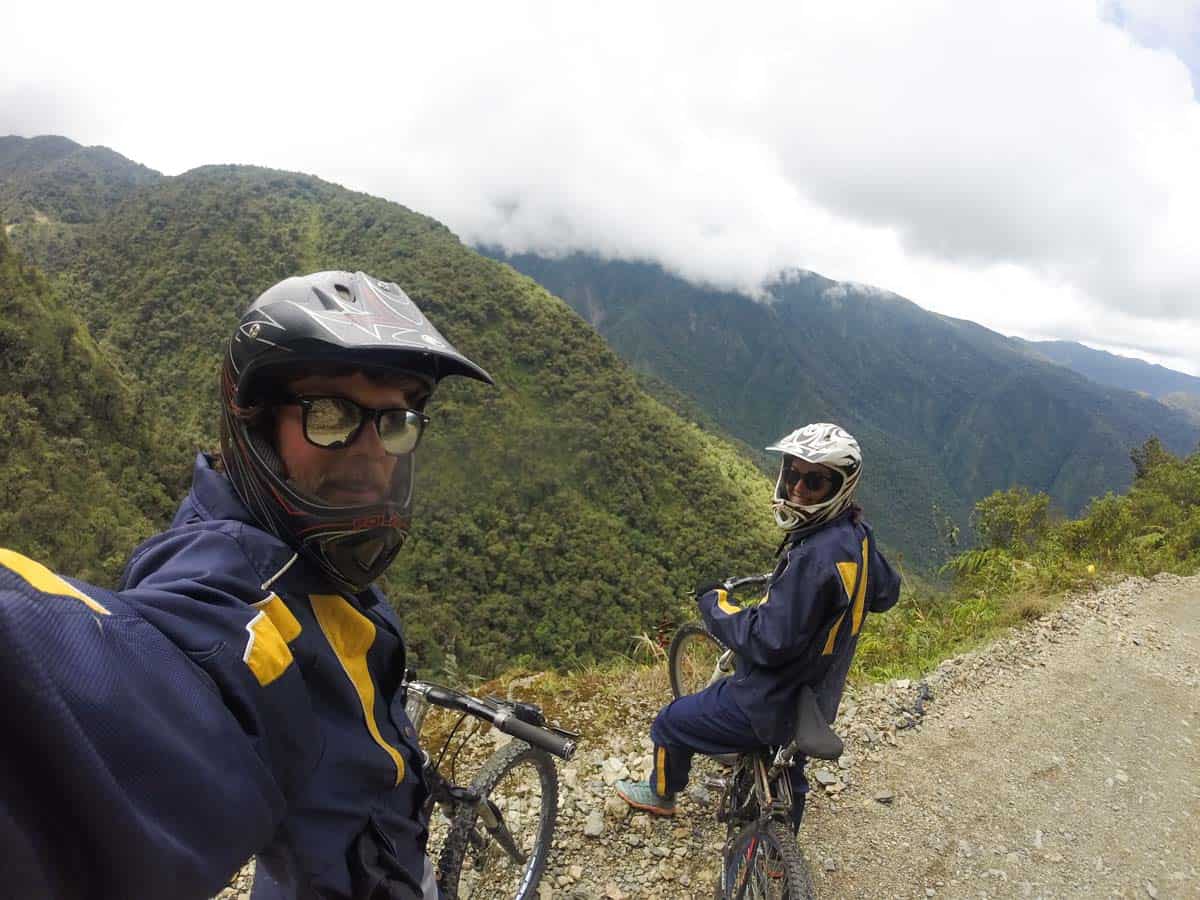 Young mountain bikers take selfie on gravel road.
