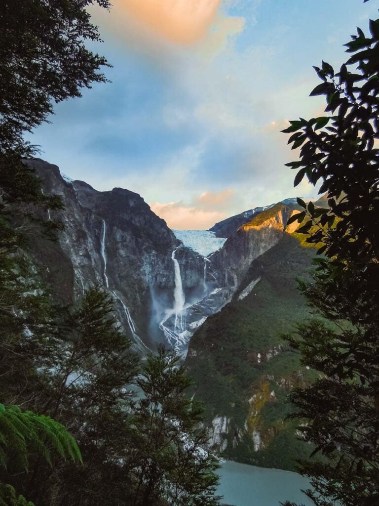 Glacier with waterfall at sunset.