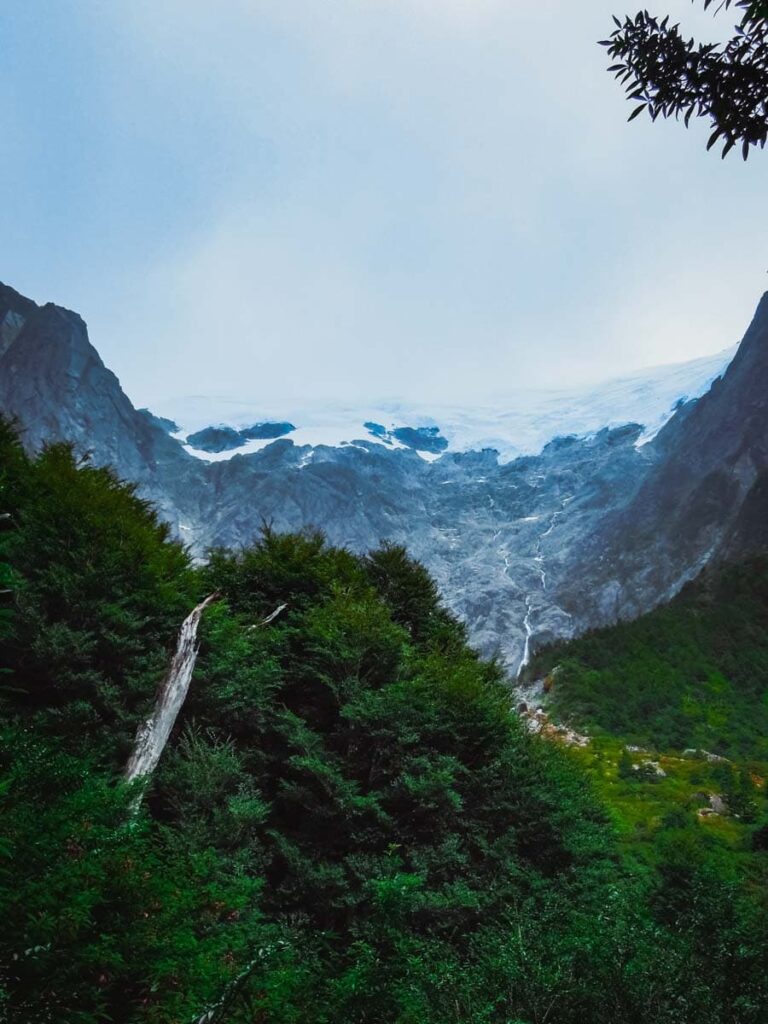 View of a glacier from below in a forest.