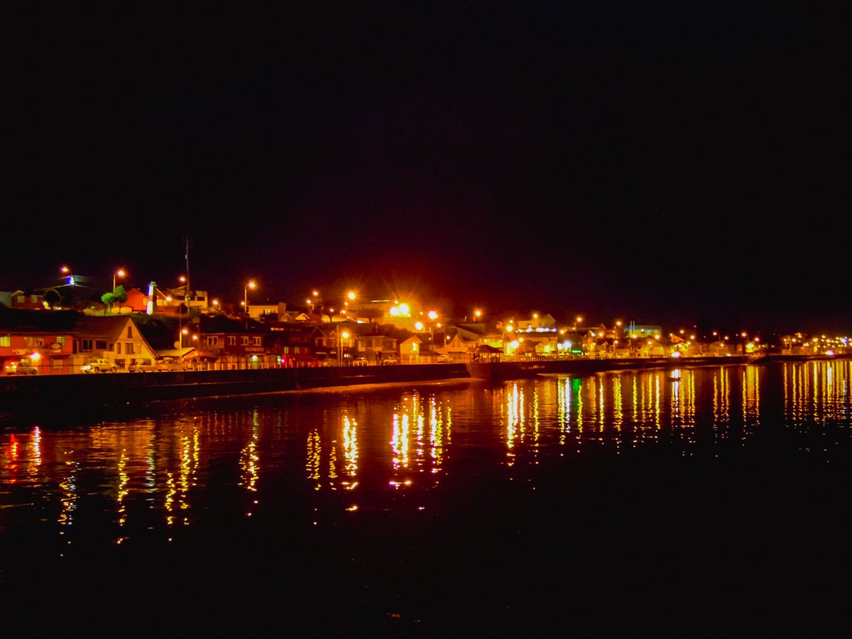 City light from ferry boat at night.