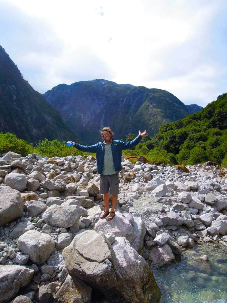 Man putting arms in air celebrating getting water in patagonia.
