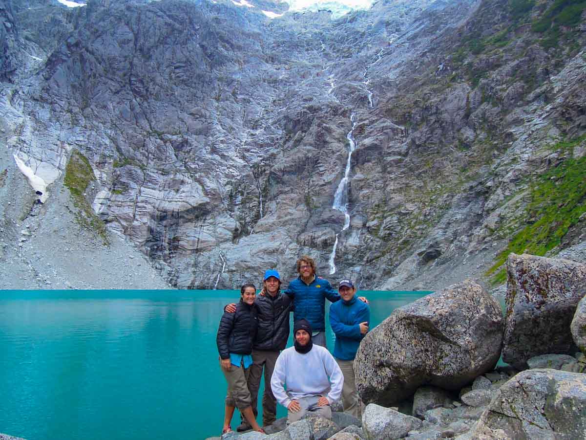 Group of hikers at glacier fed lake.