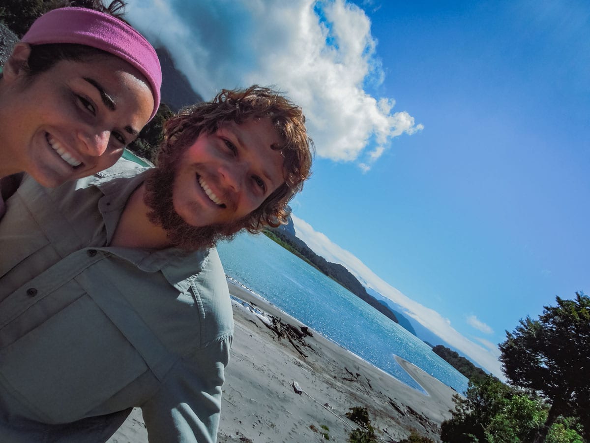Young couple take photo next to river in Chile.
