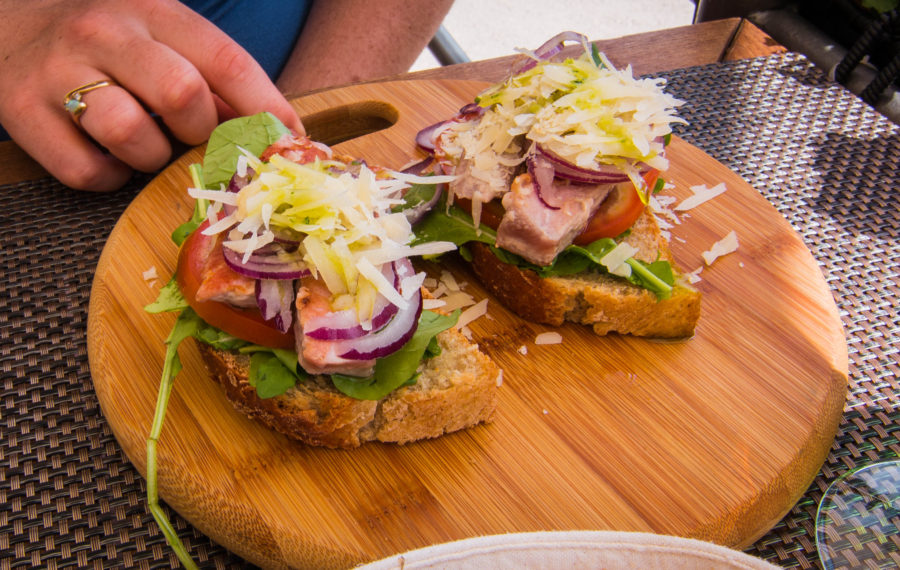Tuna bruschetta with cheese on a bamboo board
