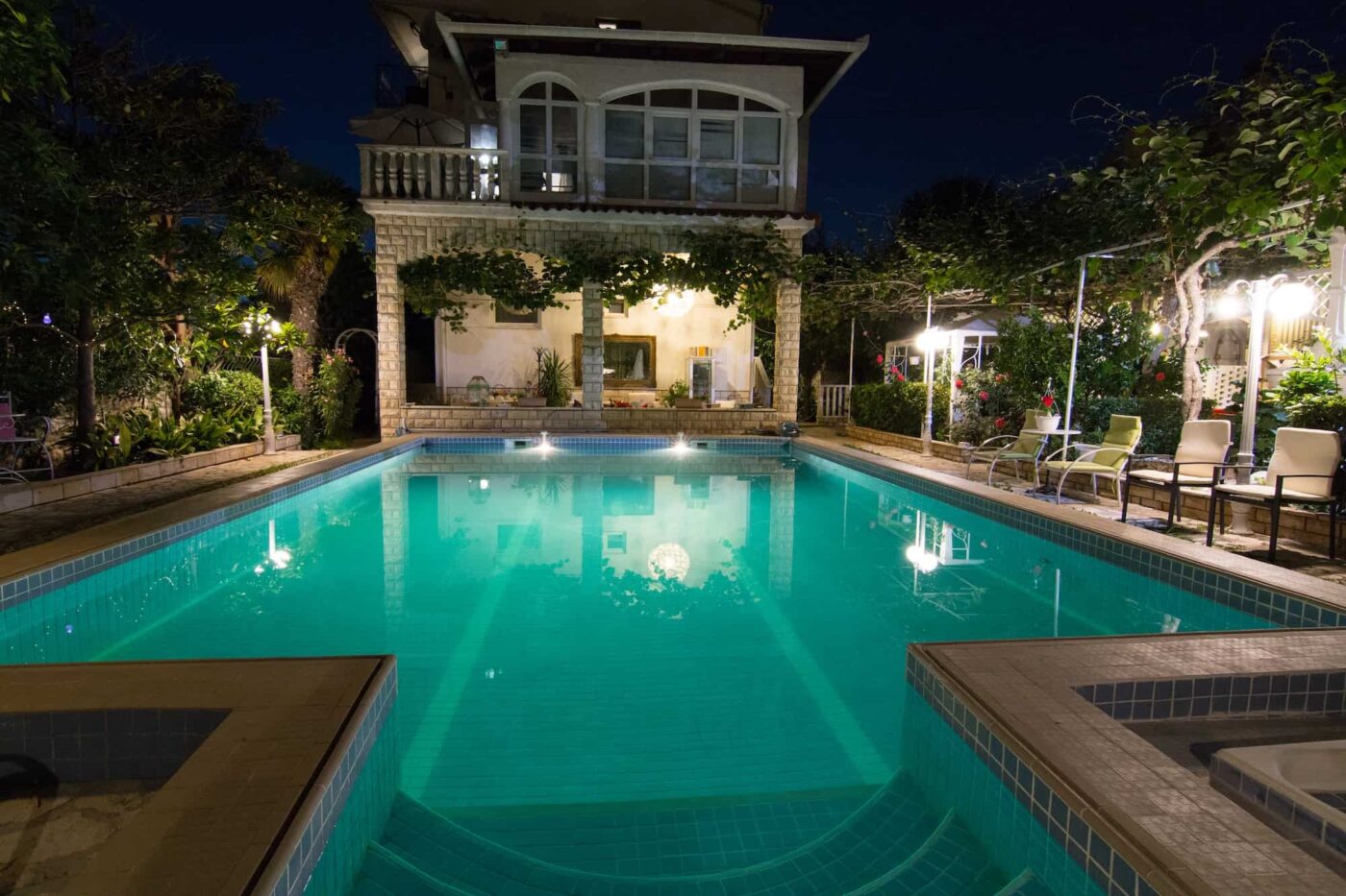lit up pool at night.