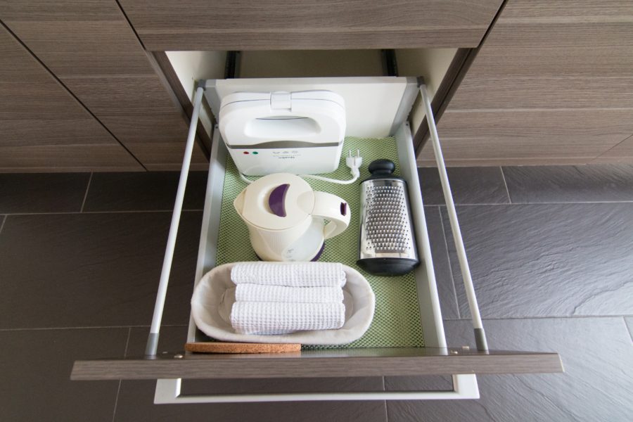 Kitchen Drawer with cheese grater, waffle iron, and kettle