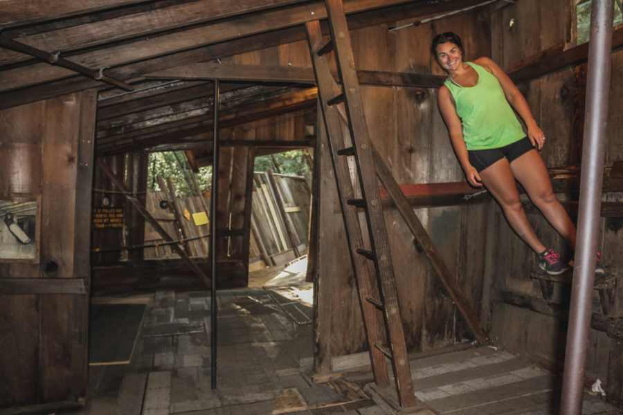 Gravity House at Confusion Hill, woman standing straight up but looks sideways.