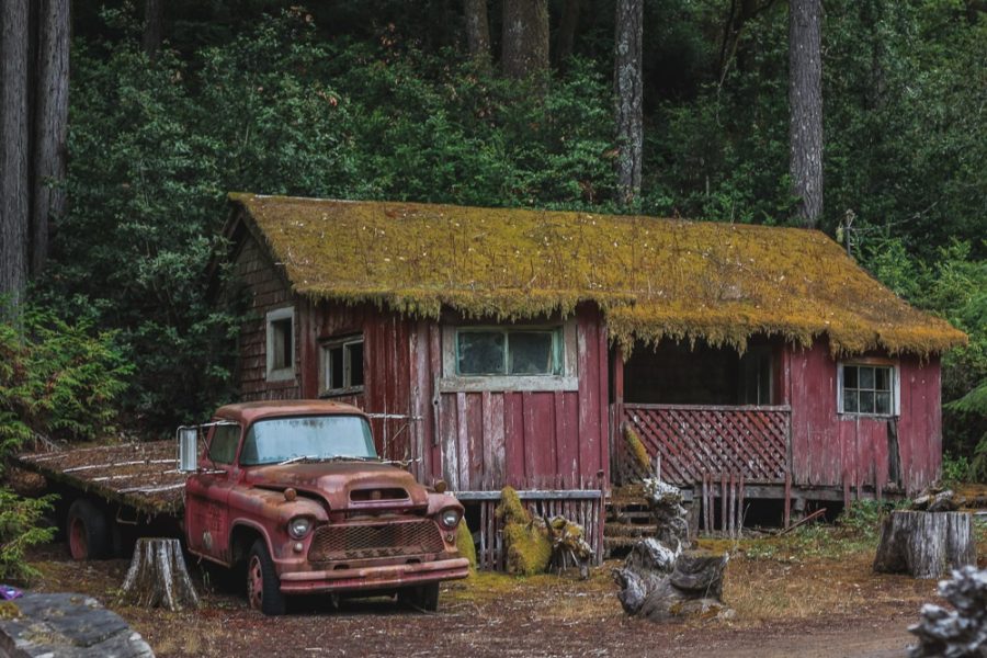 red truck and old home along Highway 1