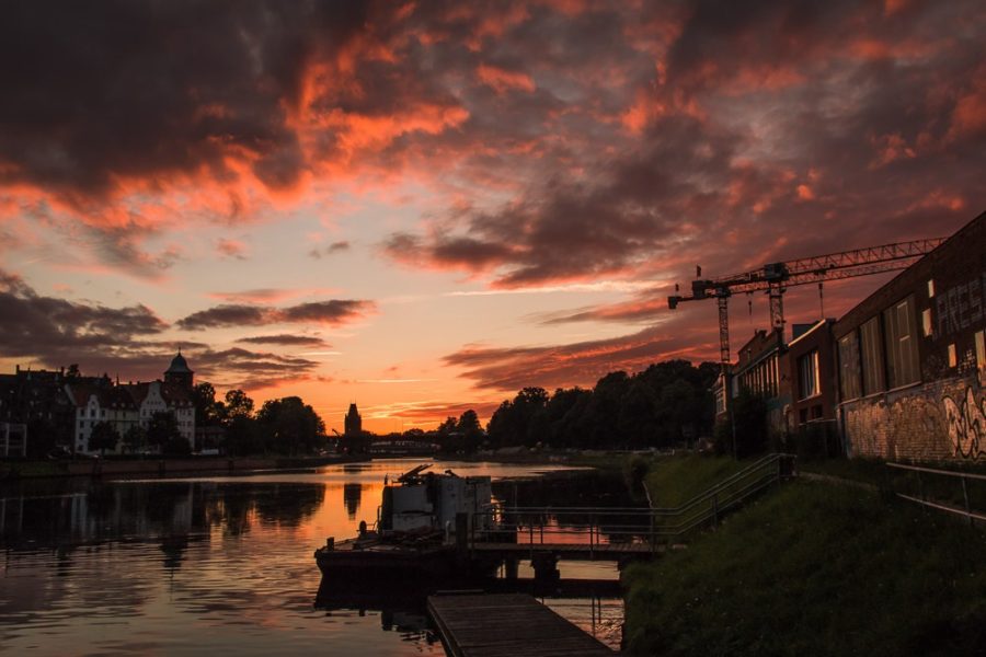 Lubeck, Germany, sunset over river, cranes at sunset, arboursabroad