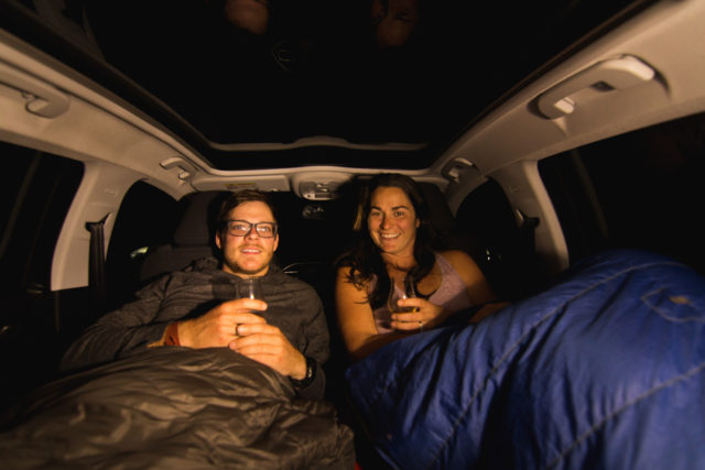 ArboursAbroad in sleepings bags in the back of a car they converted into a place to sleep while on a road trip in Scotland.