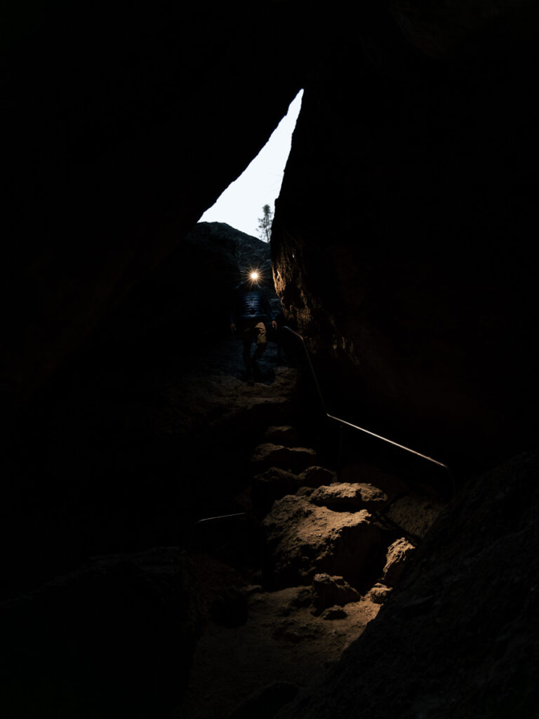 man walks into dark cave with headline on.
