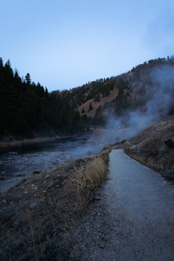 paved path leading to steaming hot springs by river, arboursabroad