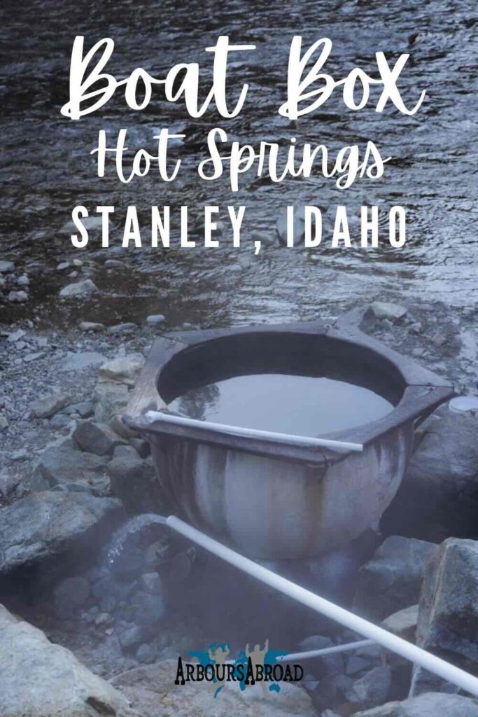 Hot spring with metal caldron near river.