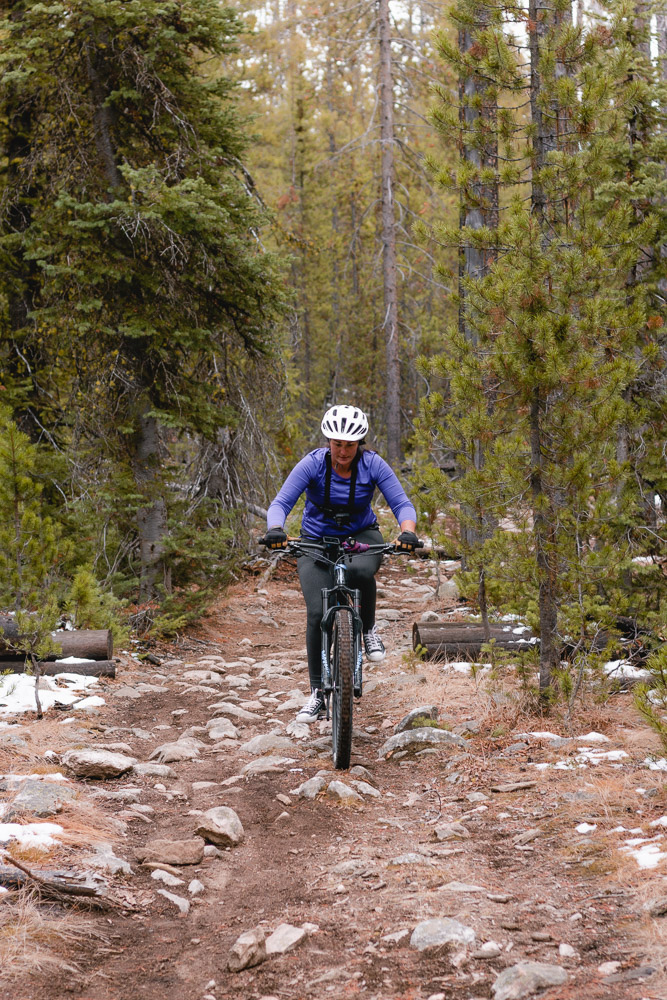 woman mountain biking over rock garden, ArboursAbroad, Stanley, Idaho