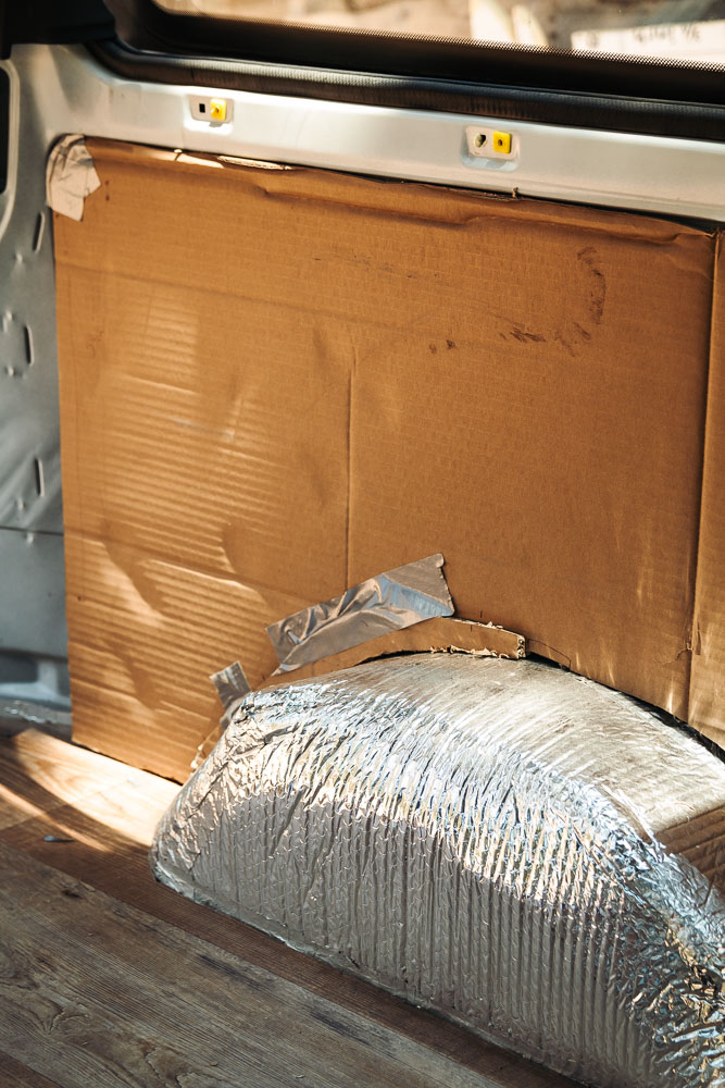 cardboard used as stencil for van panel around wheel well, arboursabroad