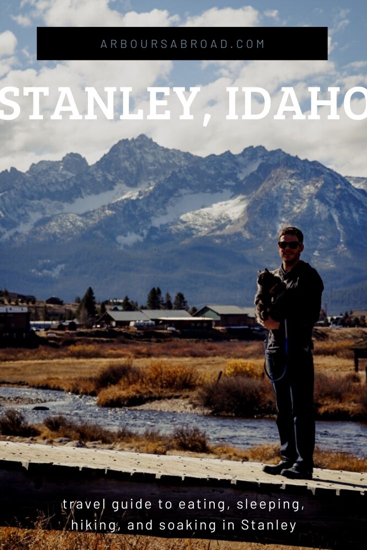 man holding cat on bridge in Stanley Idaho with Sawtooth Mountains in background, ArboursAbroad