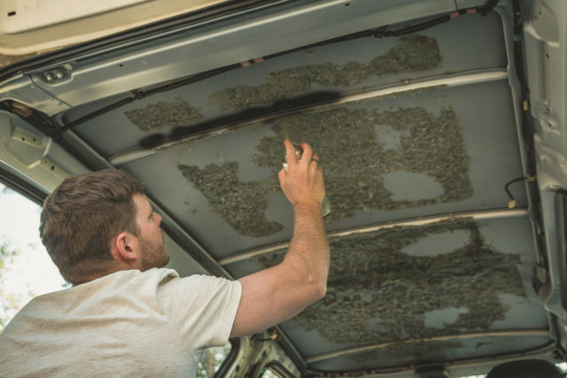 man treating rust in vehicle roof, Arboursabroad, campervan ceiling conversion