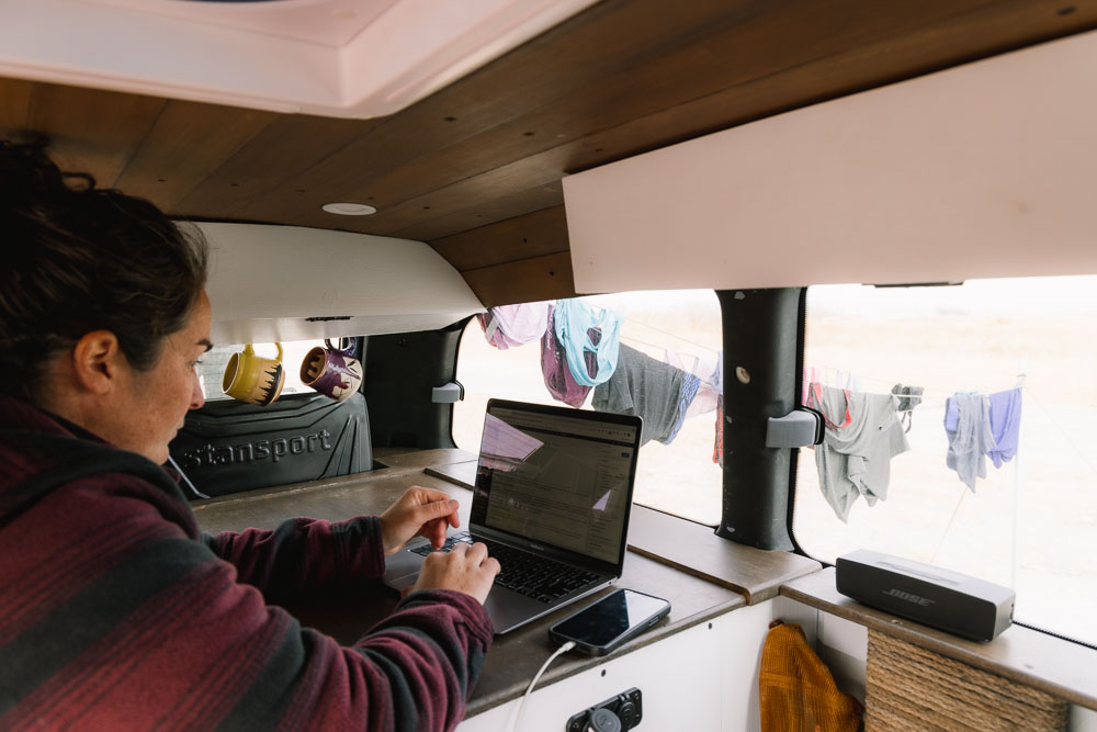 woman working from computer in van, van life jobs, arboursabroad