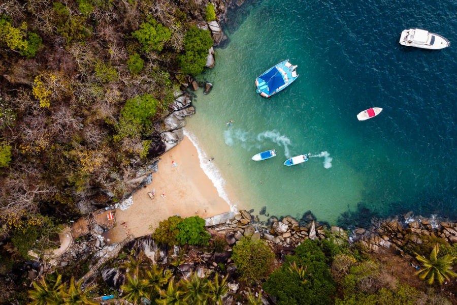 drone shot of beach in Puerto Vallarta with boats in water, ArboursAbroad