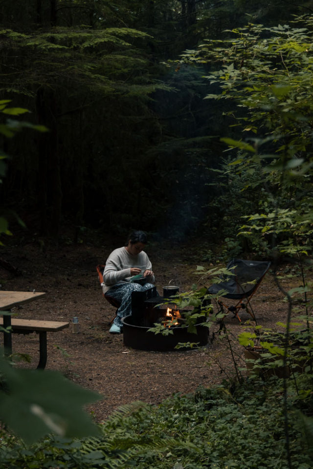woman by fire, camping, national forest camping, arboursabroad