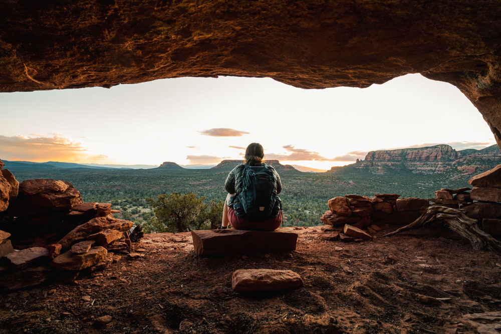 best sunset hikes Sedona, ArboursAbroad, Sedona guide, Arizona, Altar Cave with woman in it