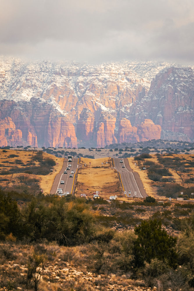The highway leading into Sedona with a lens compressing the red rocks close to the highway for a more dramatic view.
