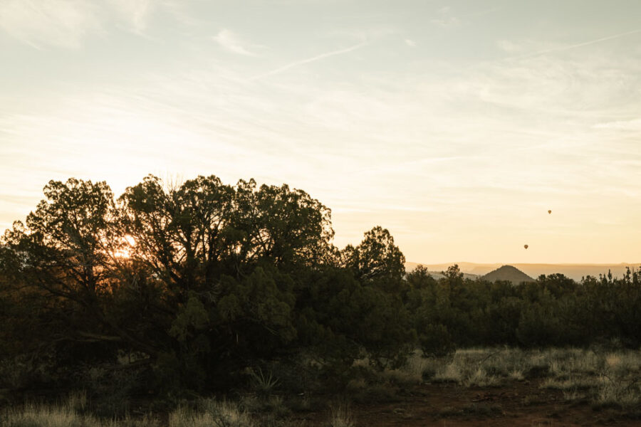 Sunrise from Nolan Campground looking toward Sedona with hot air balloons in the sky.