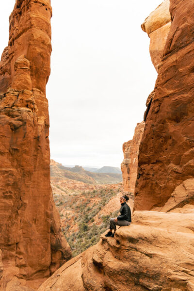 Woman sitting at Cathedral Rock looking into the Vortex.