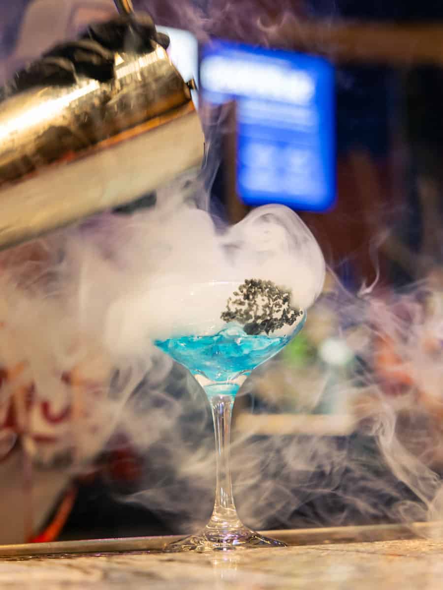 Blue drink on the Las Vegas Strip with smoke billowing around it.