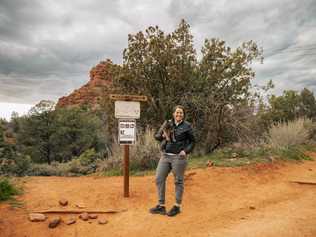 Heather holding her cat, Georgie on the Lower Chimney Rock Trail around the base of Little Sugarloaf Mountain.
