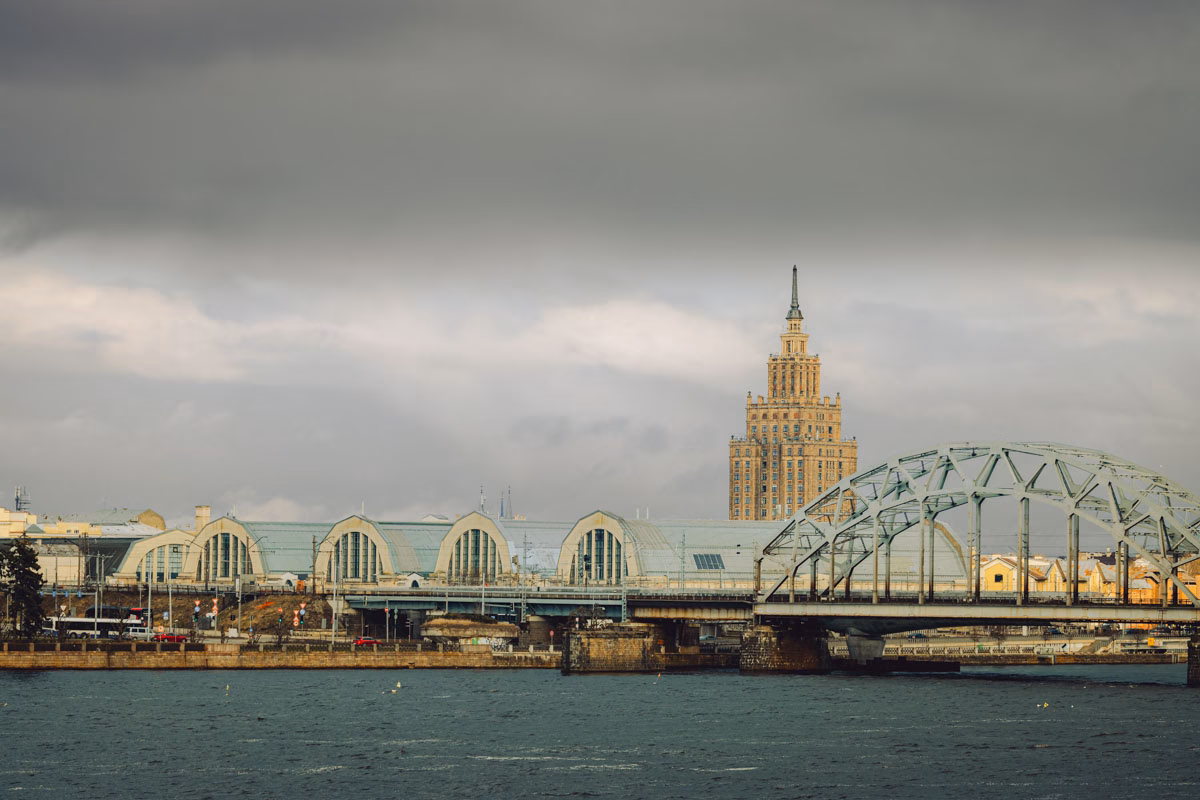 The iconic arches to the Riga Central Market with the Science Building behind and the train bridge over the river.