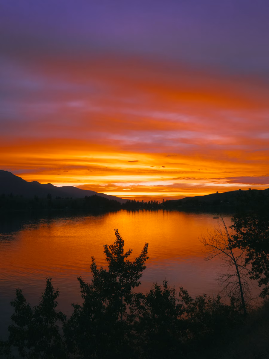 Vivid purple and orange sunset reflecting on a lake in Joseph, Oregon.