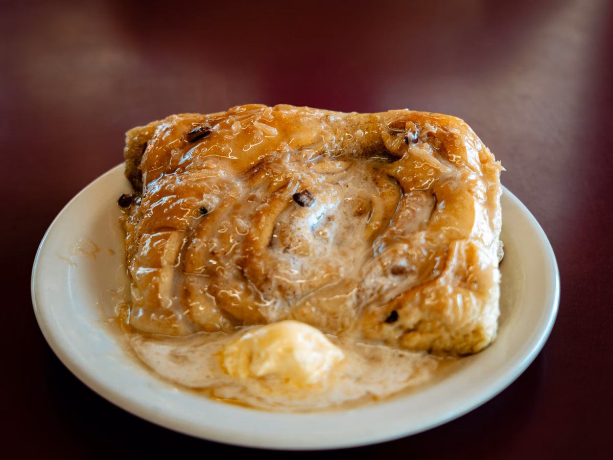 Fresh cinnamon roll pastry served at Cheyenne Café in Joseph, Oregon with melted butter as the topper.