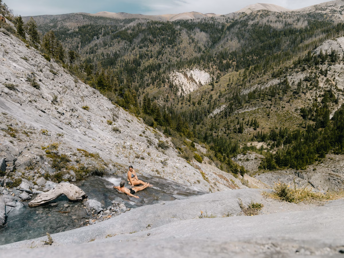 Heather and Jason from ArboursAbroad relaxing in the waters on their canyon and creek views along the Slick Rock Creek Falls hike in Joseph, Oregon.