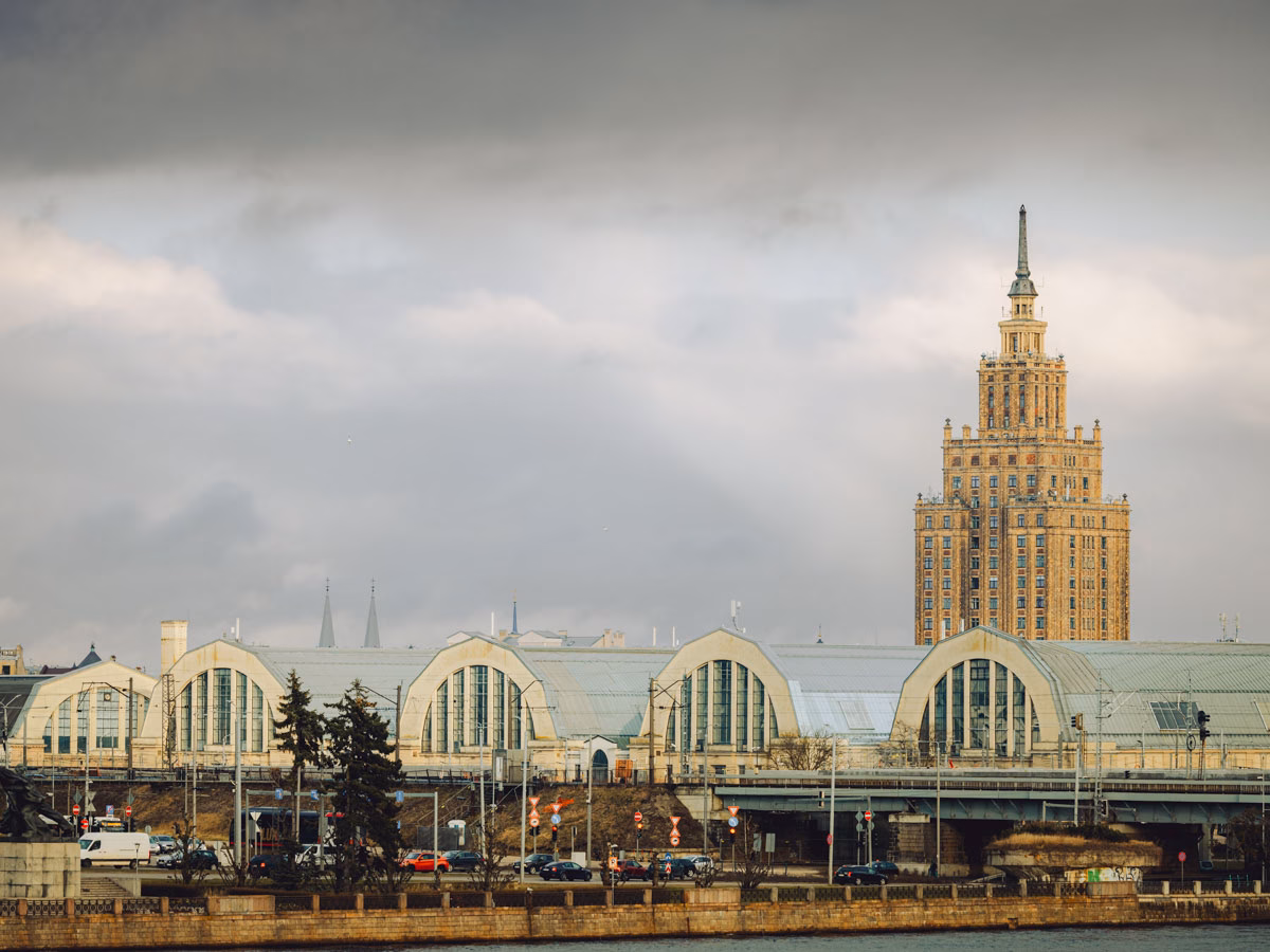 Riga Central Market pavilions with the Academy of Sciences tower rising in the background.
